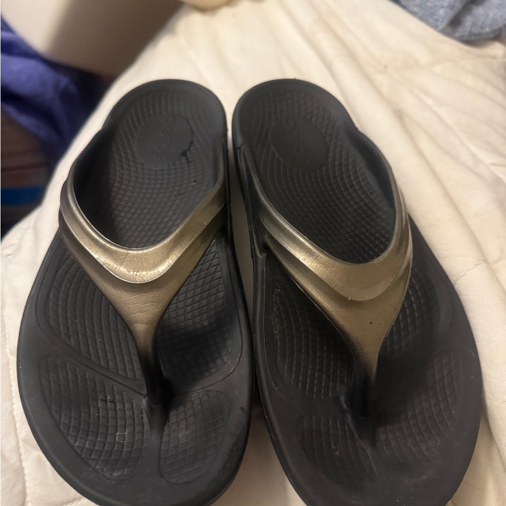 OOFOS Black and Gold Flip Flops